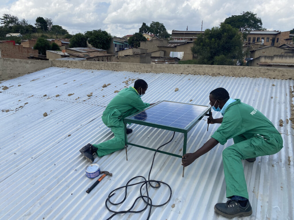 Installing a SHS at a house in Kazo, Uganda